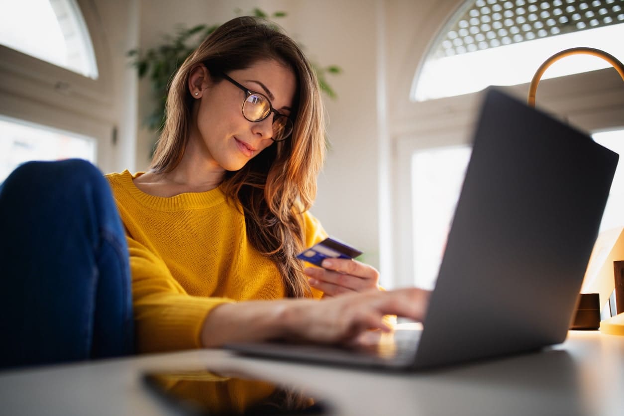 Eurolife blog- woman processing an online transaction on lap top 