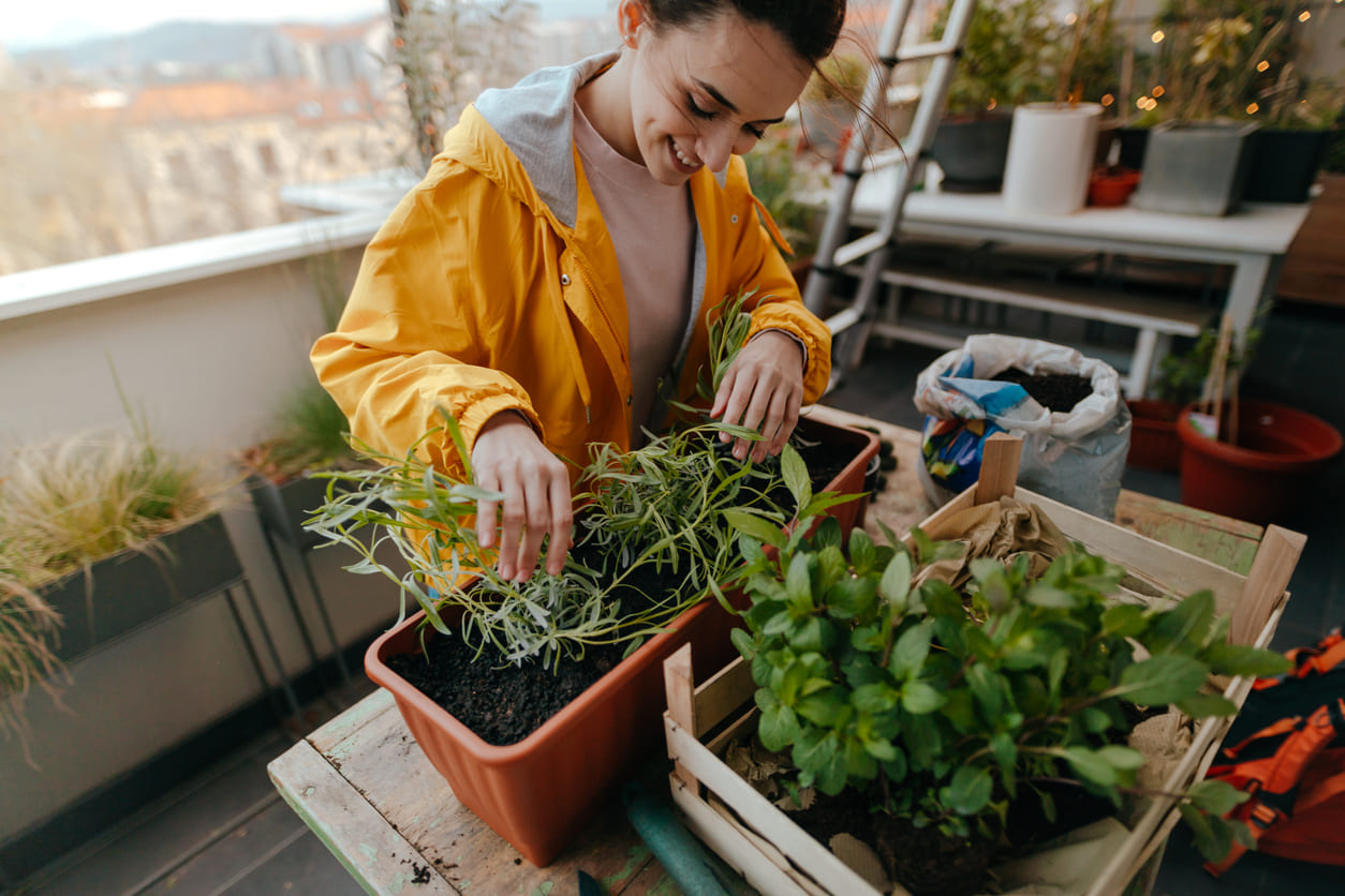 Eurolife FFH blog - woman taking care of plants at her balcony
