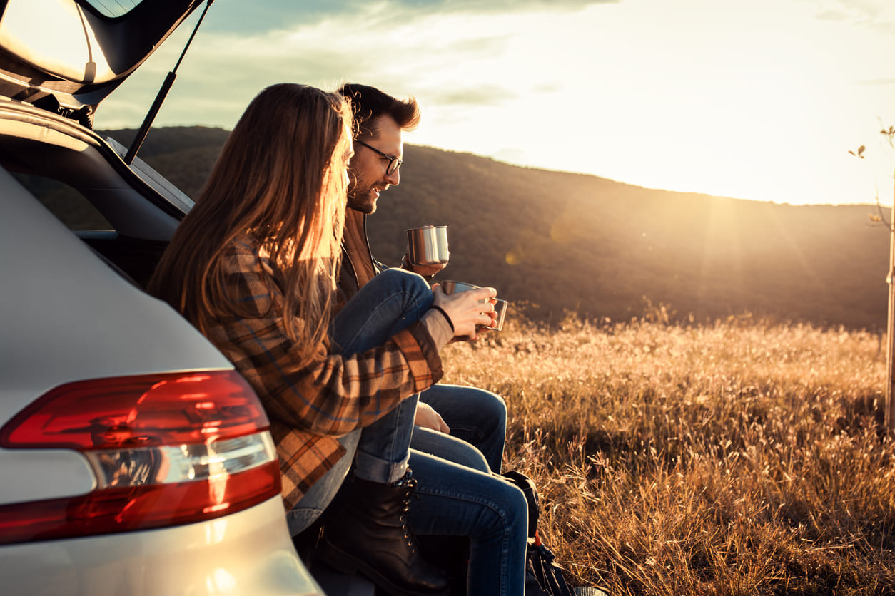 Eurolife blog - couple resting with coffee at their car outdoors