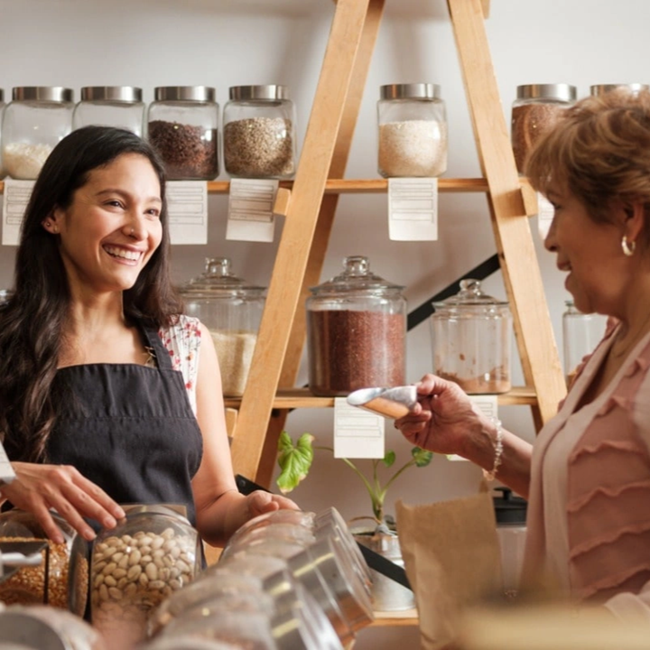 girl smiling to a woman customer at a store