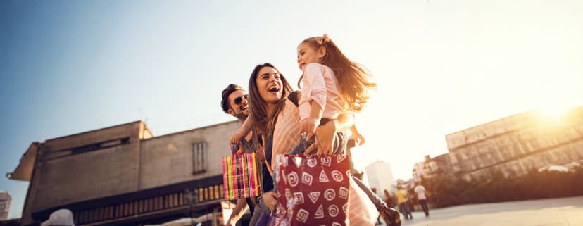 Low angle view of cheerful family having fun during a shopping day in the city.